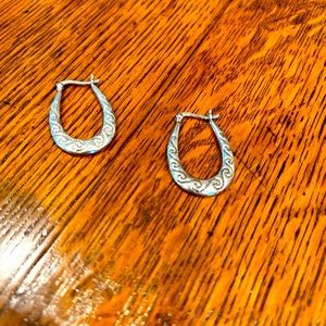Gorgeous One inch long sterling silver hoops. Clasp hook closure.